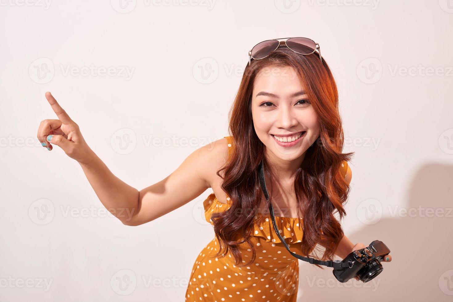 Joyful girl traveler curiously pointing to the sky photo