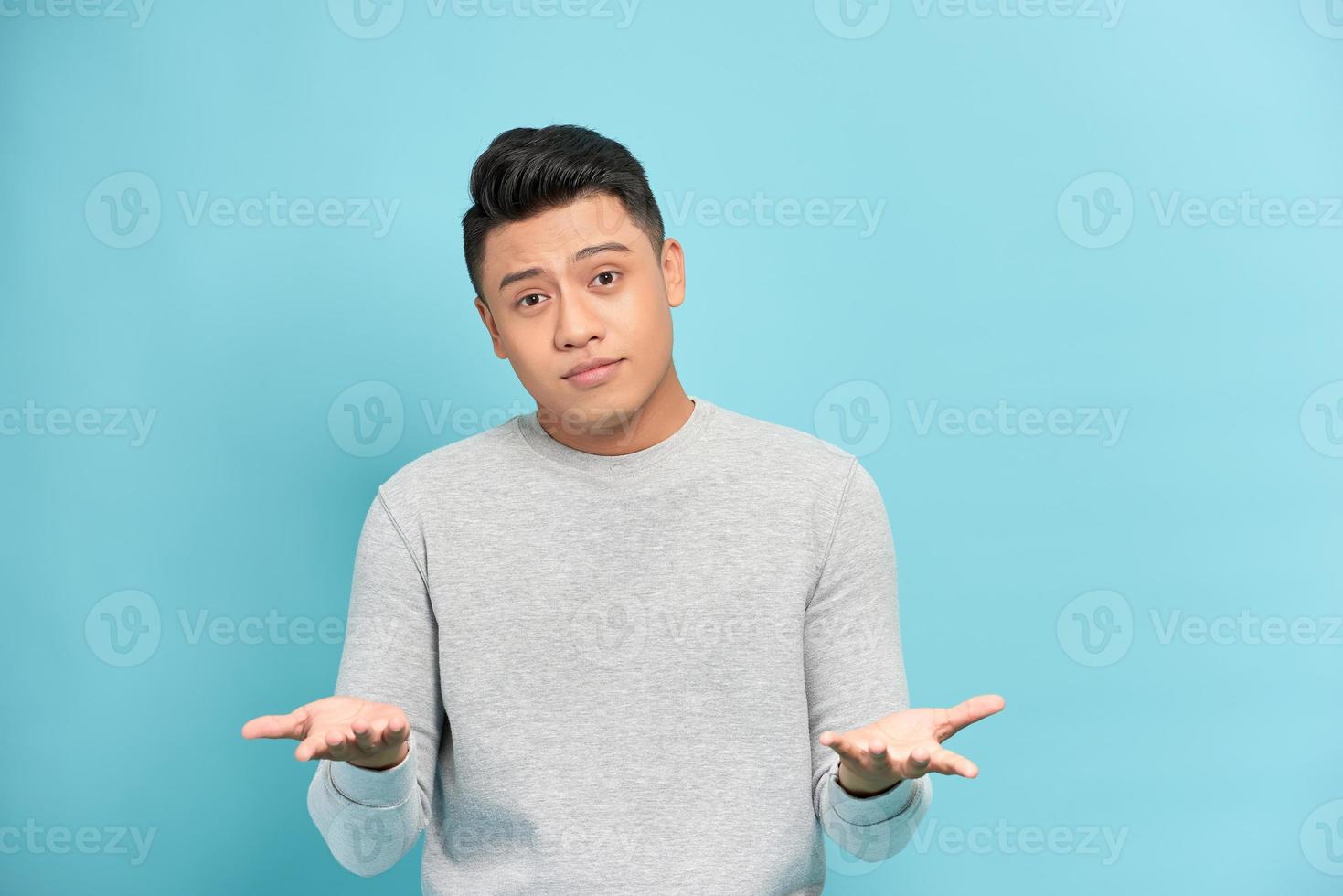 Young handsome man against a white background celebrating a victory or success, he is surprised and shocked. photo