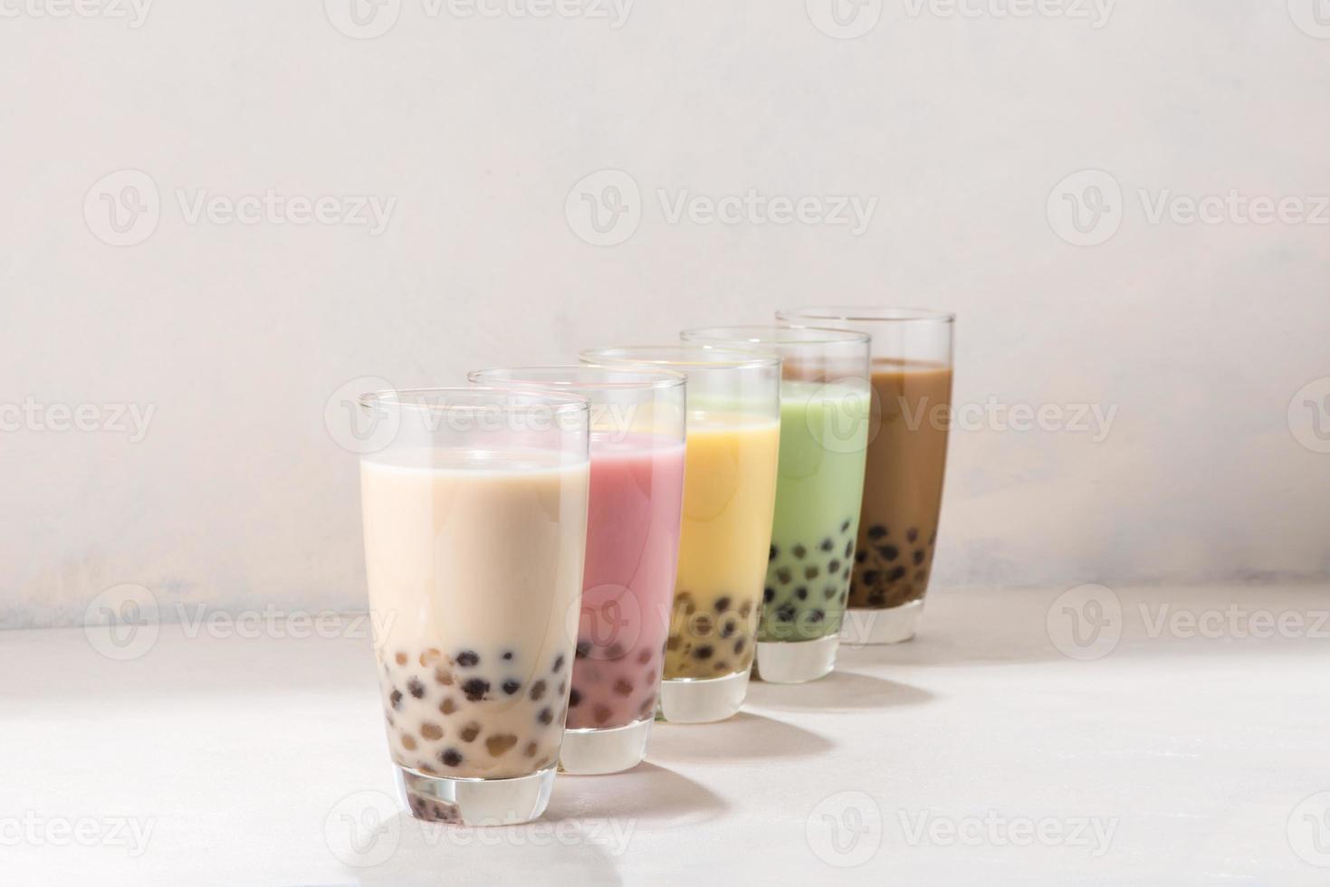 Various flavored buble tea or boba tea with straws on white background photo