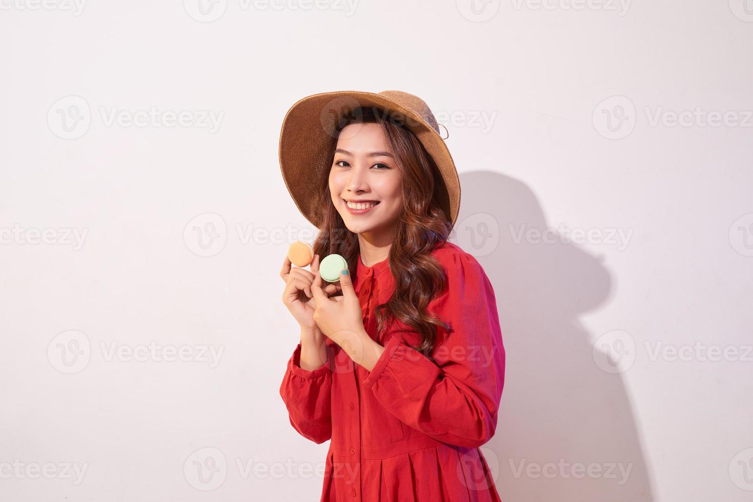Happy girl plays with macaroons. photo