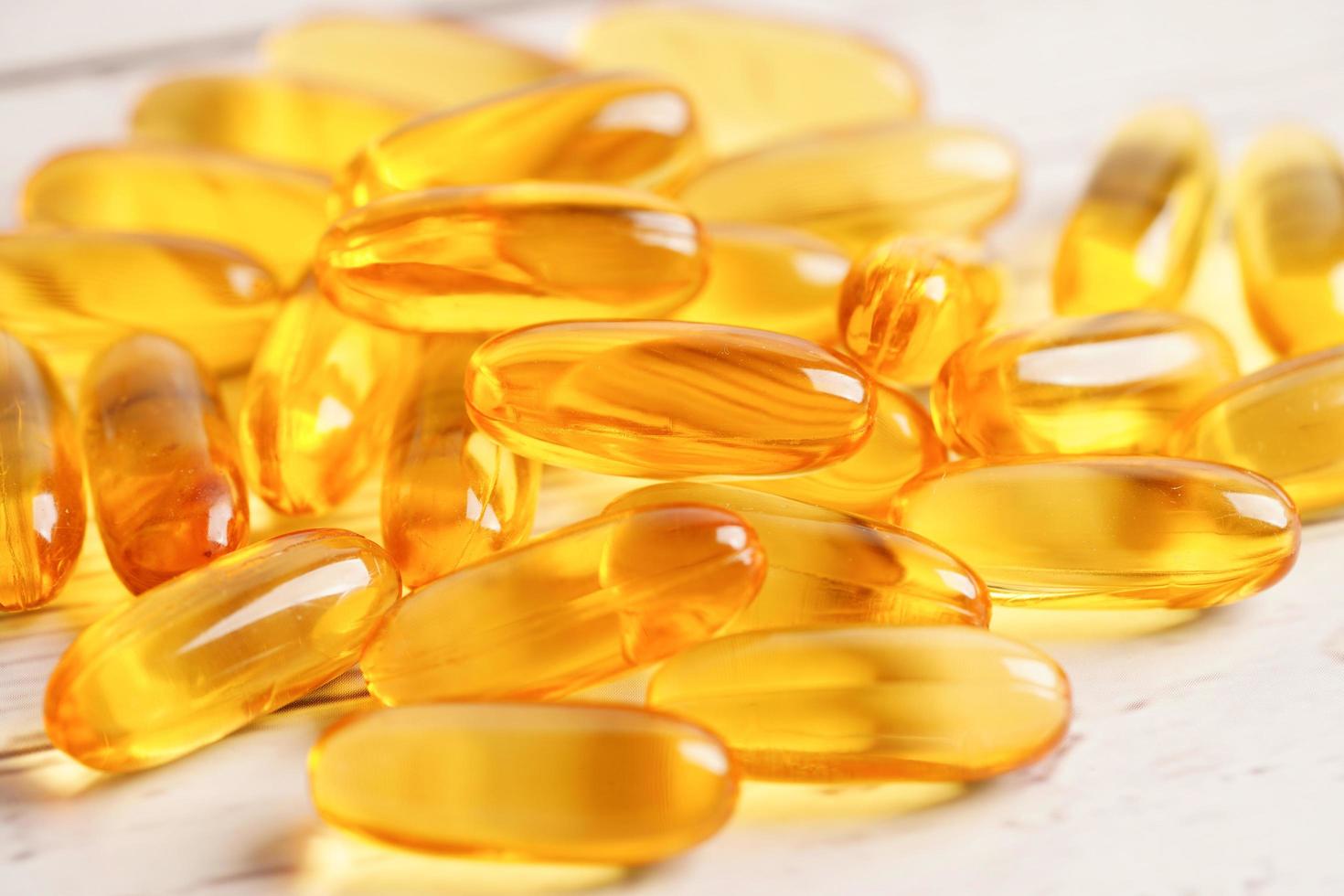 Fish oil or Cod liver oil gel in capsules with omega 3 vitamins, supplementary healthy food photo