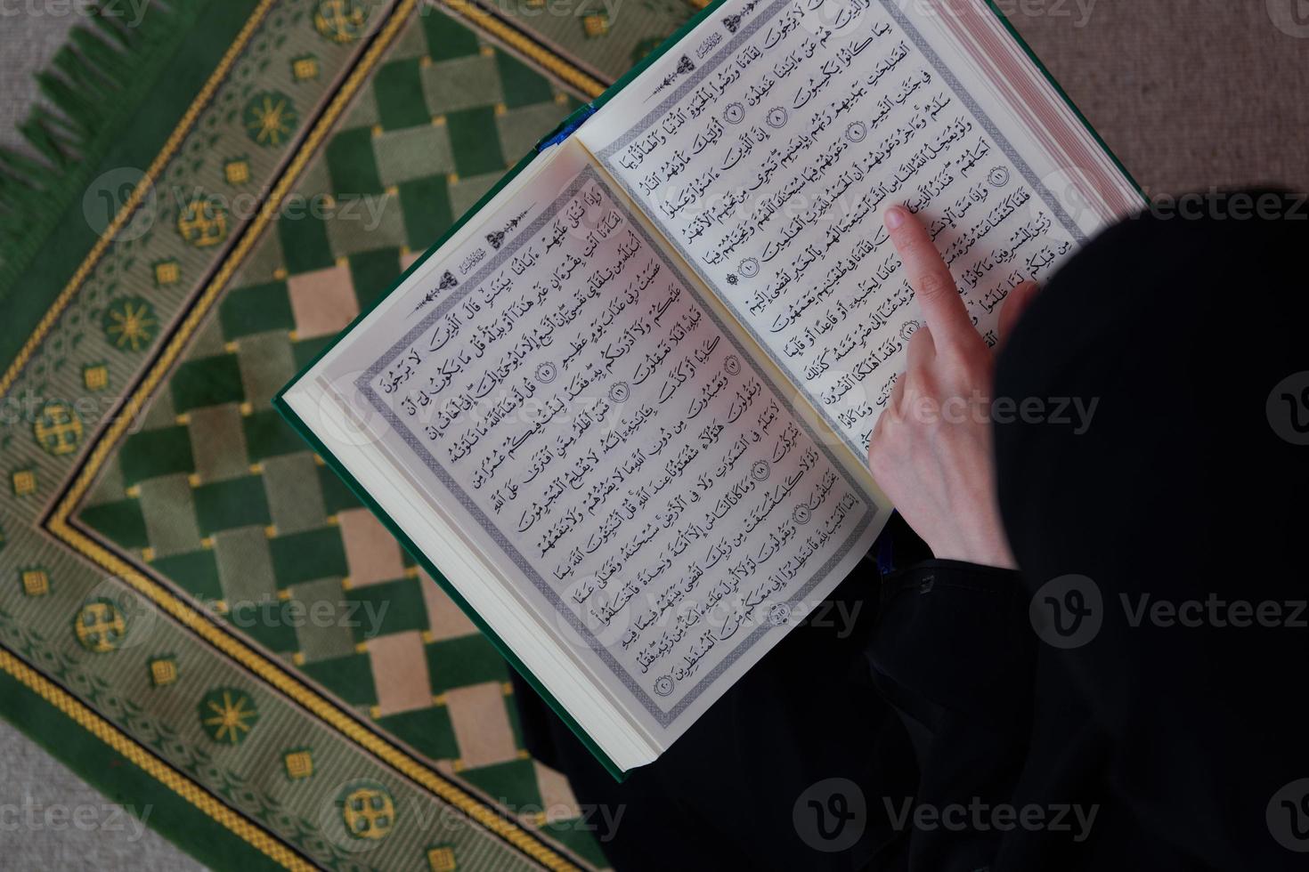 Middle eastern woman praying and reading the holy Quran Sarajevo photo