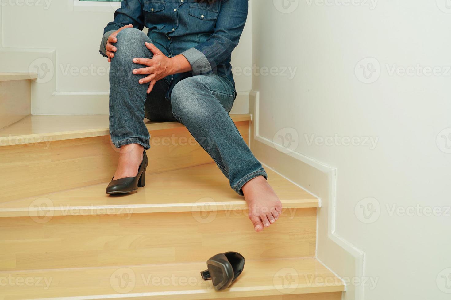 Asian business woman pain ankle, foot with leg cramp and fall down the