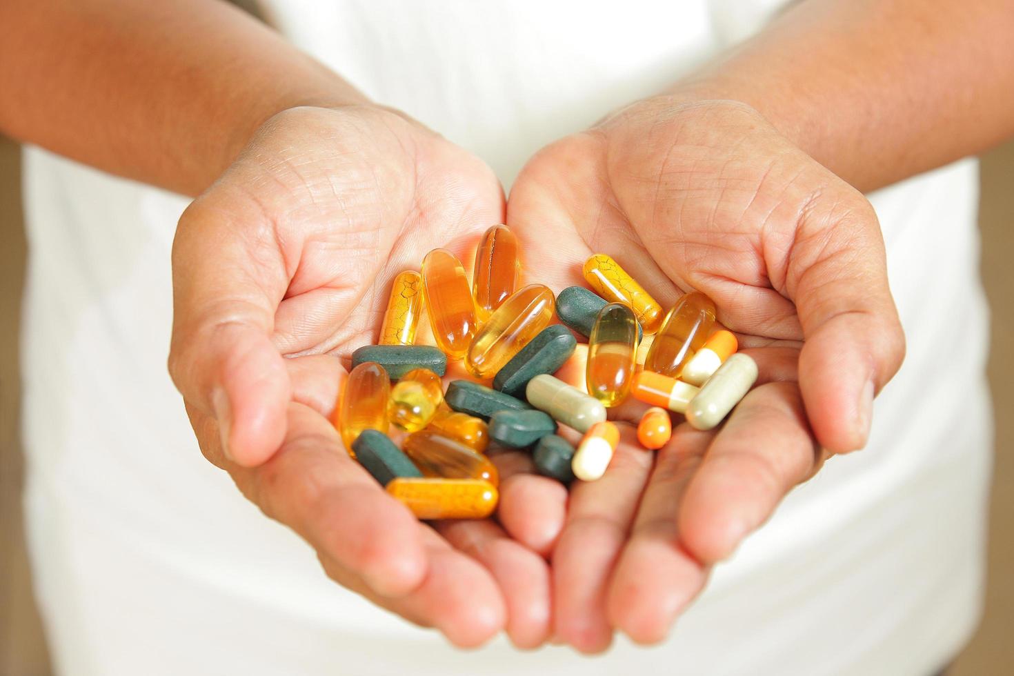 Medication in the hands of the elderly. photo