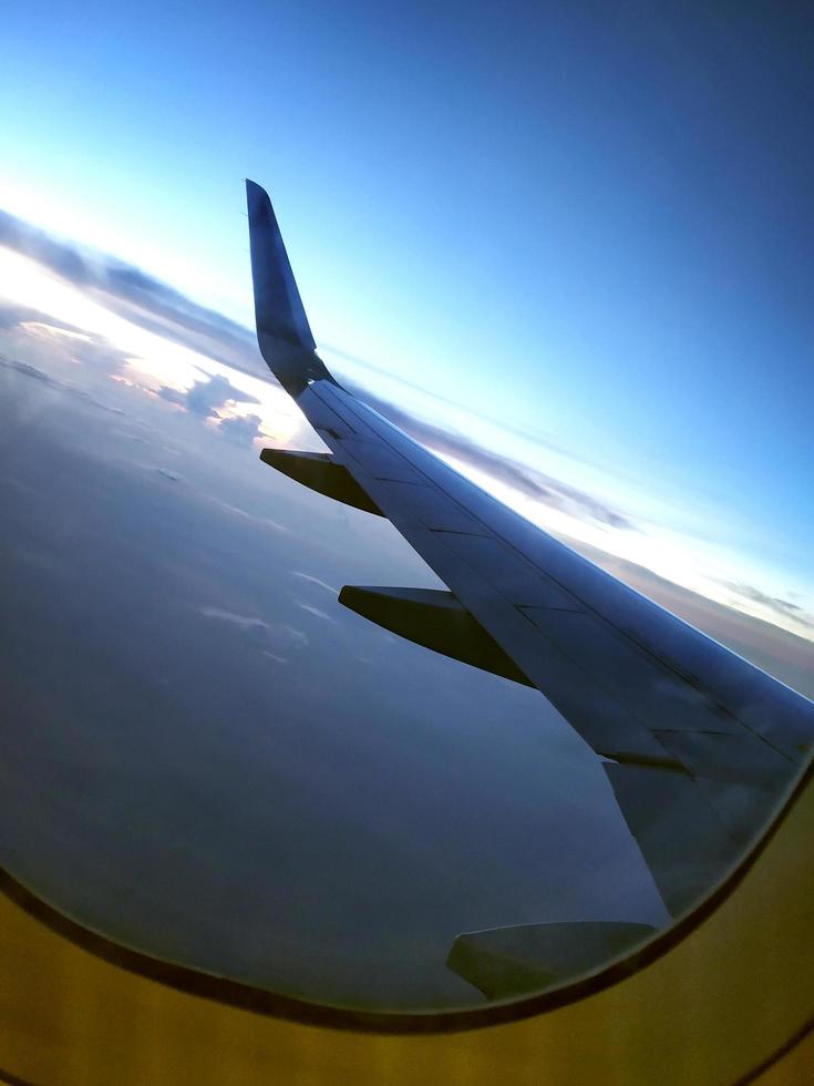 Clouds and sky view as seen through window of an aircraft photo