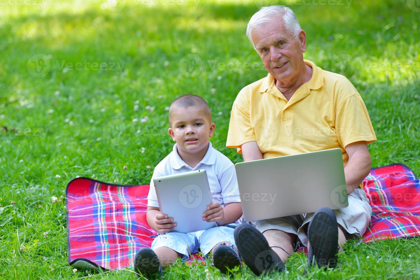grandfather and child using laptop photo