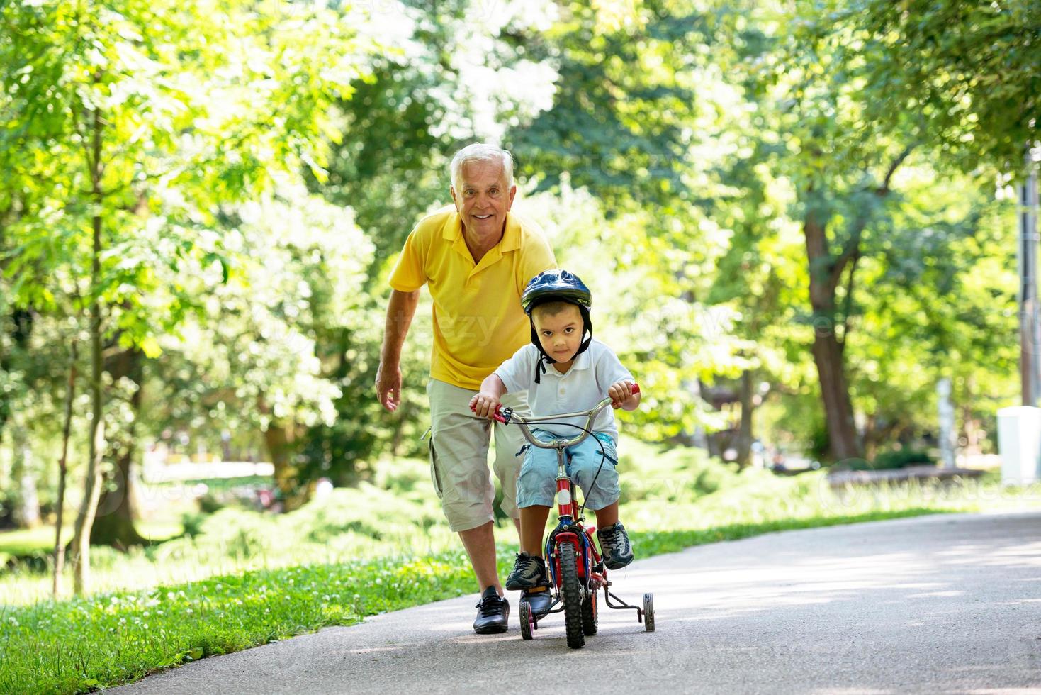 grandfather and child have fun  in park photo