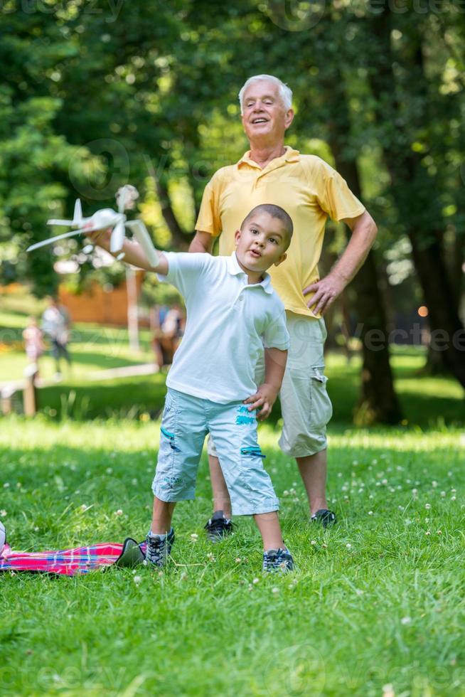 grandfather and child have fun  in park photo