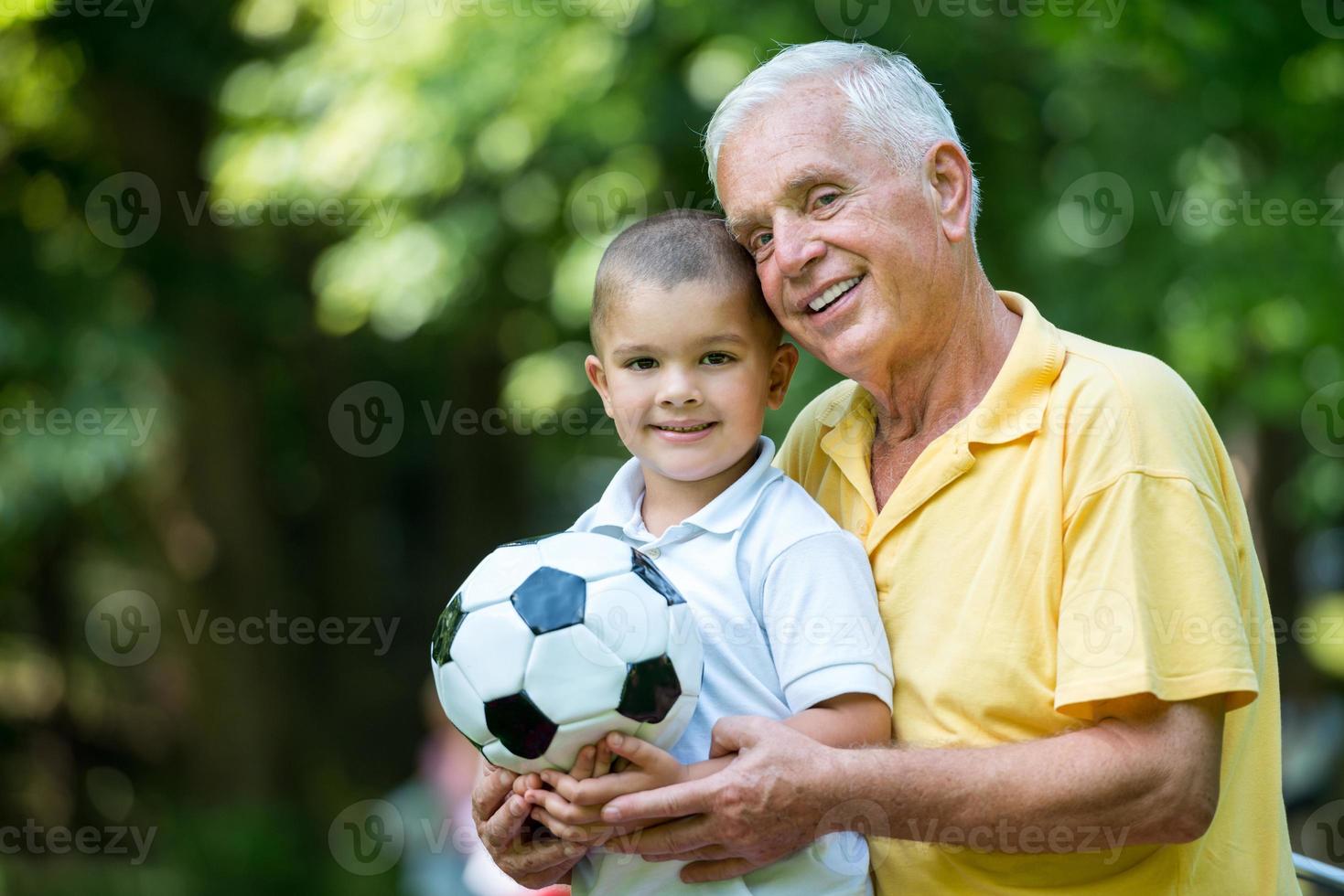 grandfather and child have fun  in park photo