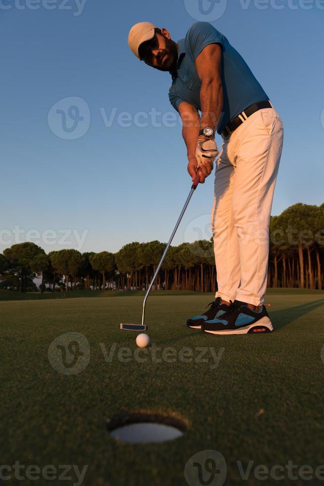 golfer  hitting shot at golf course photo