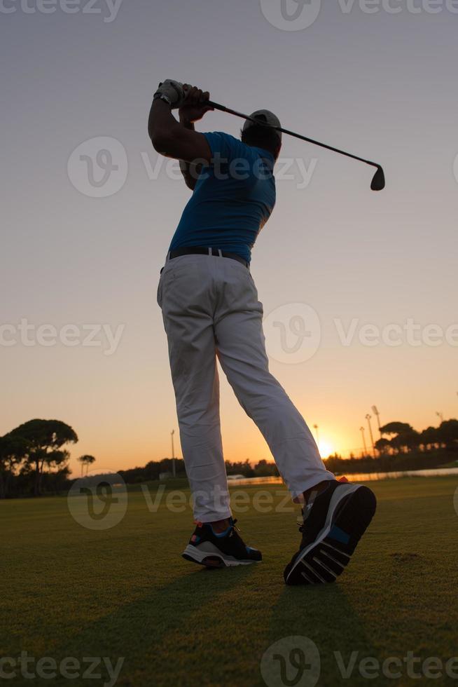 golfer hitting long shot photo