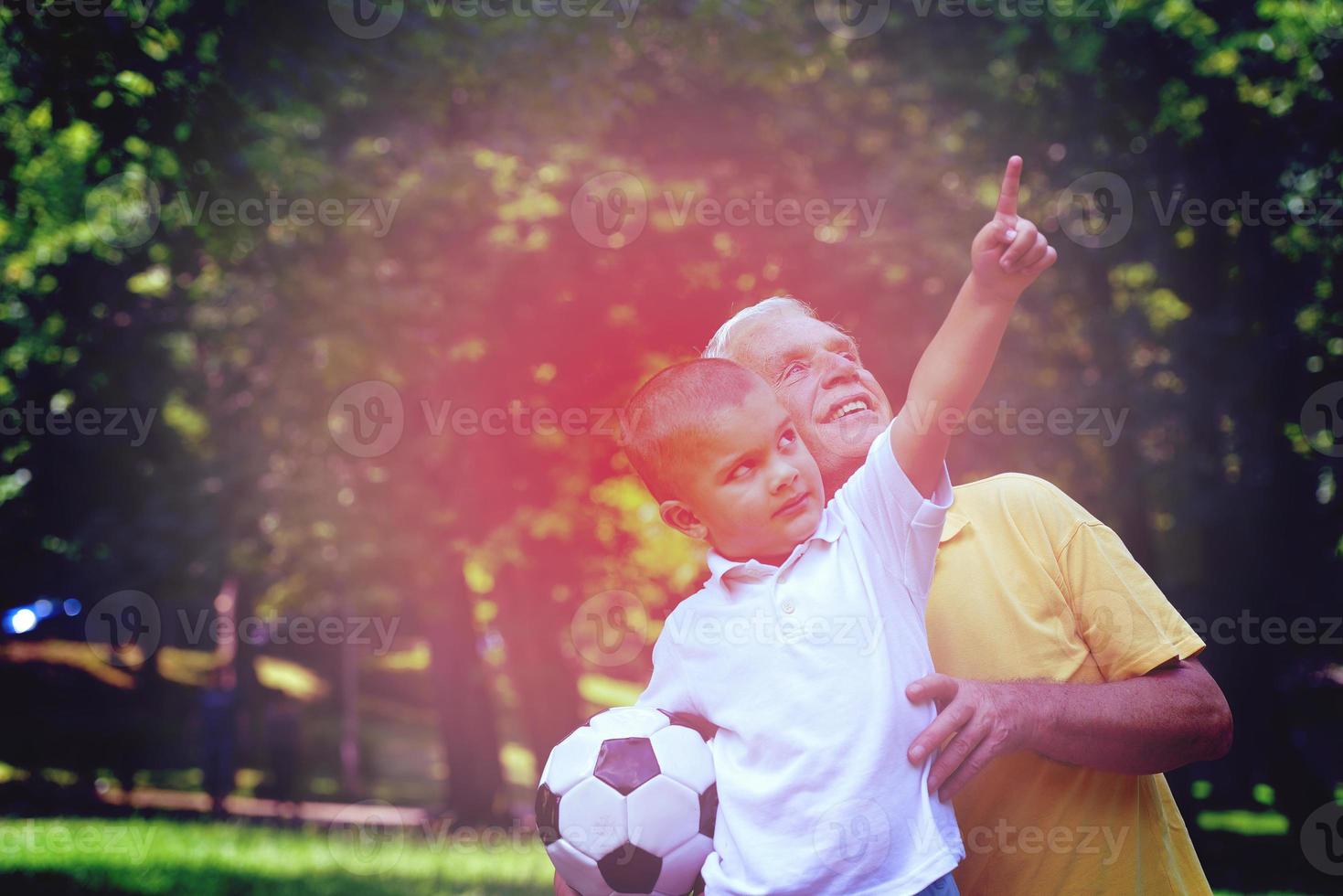 happy grandfather and child in park photo