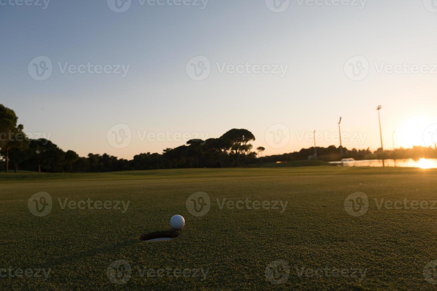 golf ball on edge of  the hole photo