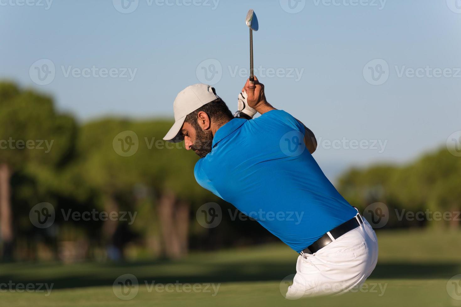 pro golfer hitting a sand bunker shot photo
