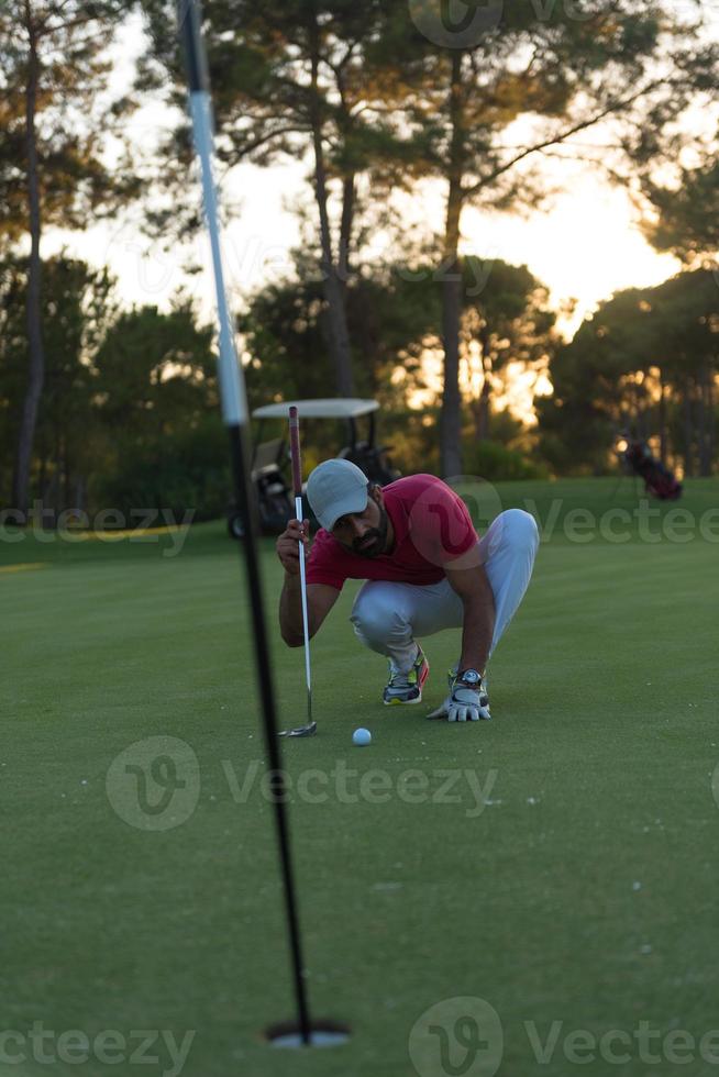 golf player aiming perfect  shot on beautiful sunset photo