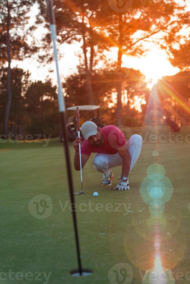 golf player aiming perfect  shot on beautiful sunset photo