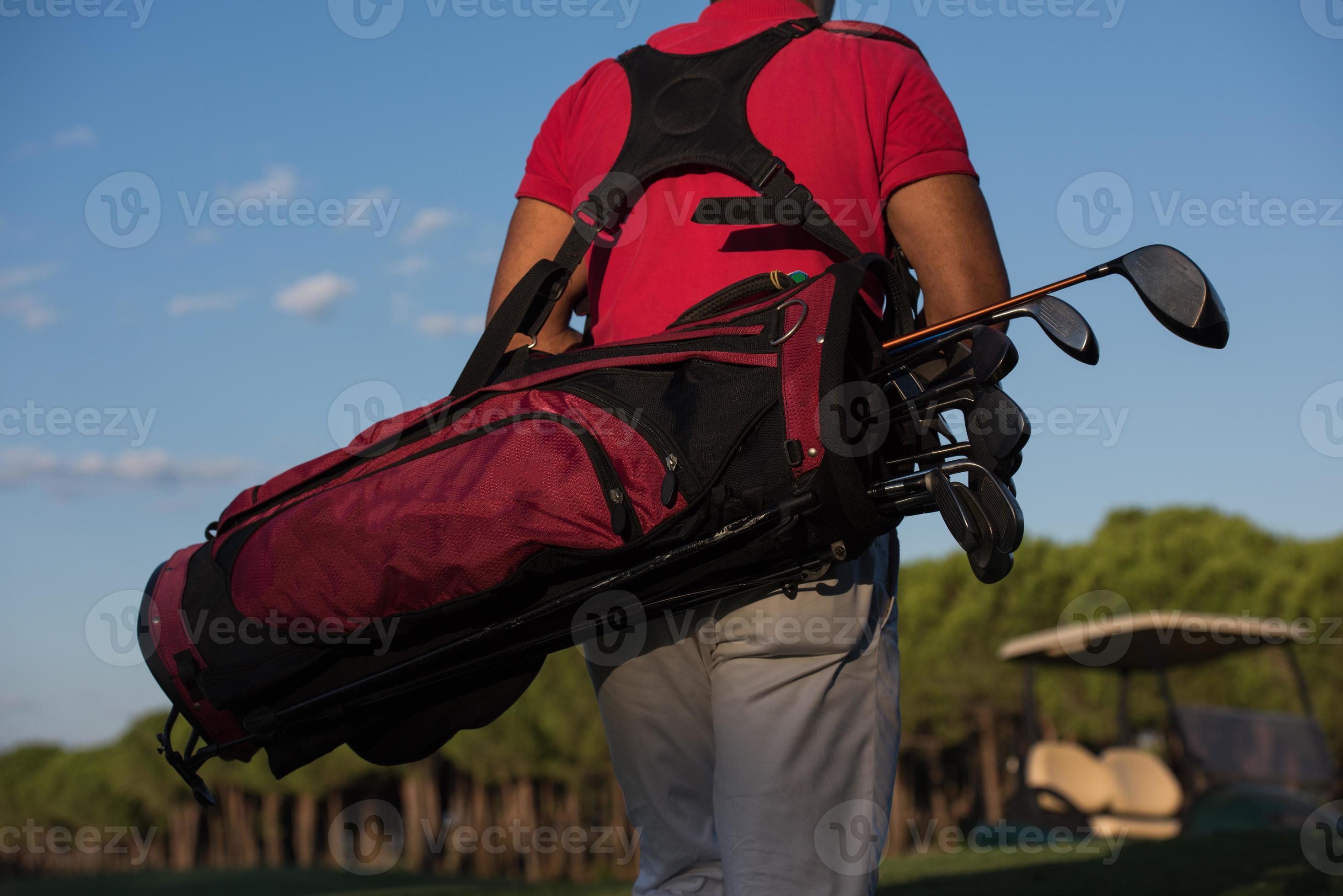 close up of golfers back while walking and carrying golf bag 10854913