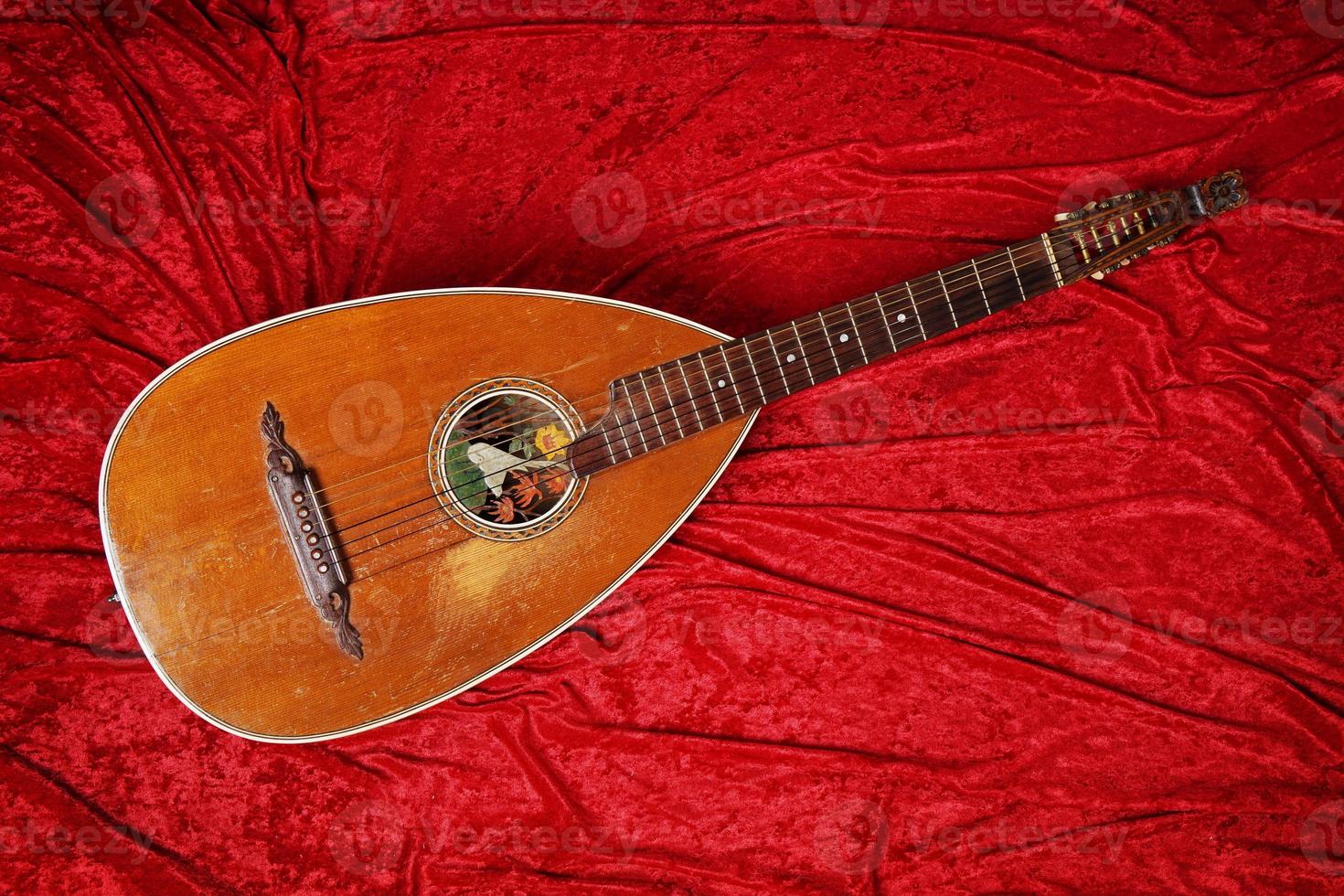 lute instrument on red velvet photo