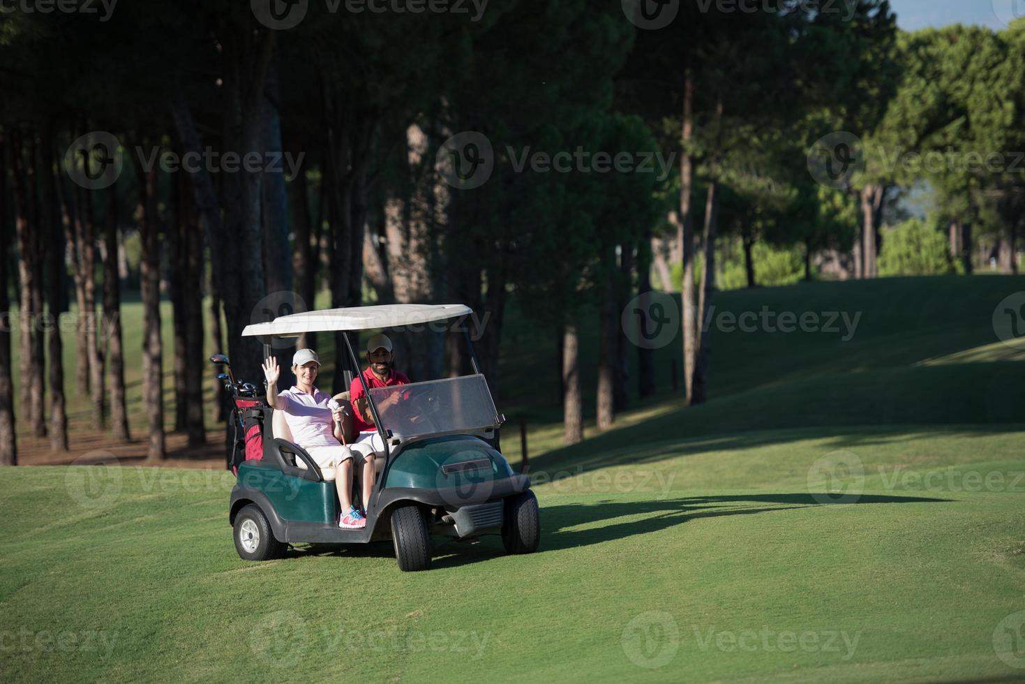 couple in buggy on golf course photo