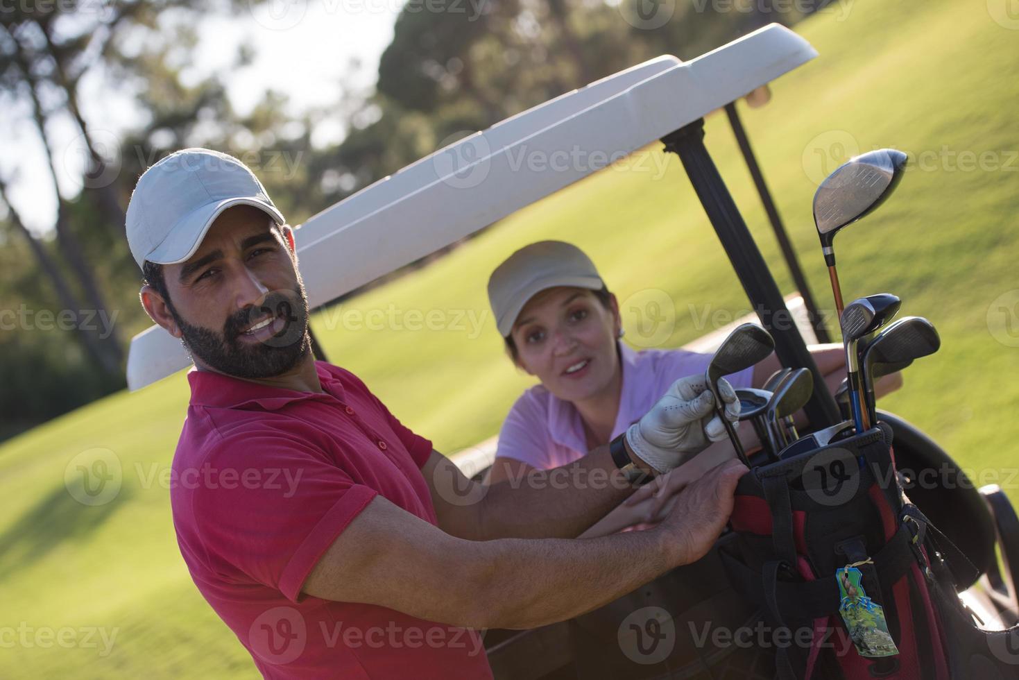 couple in buggy on golf course photo