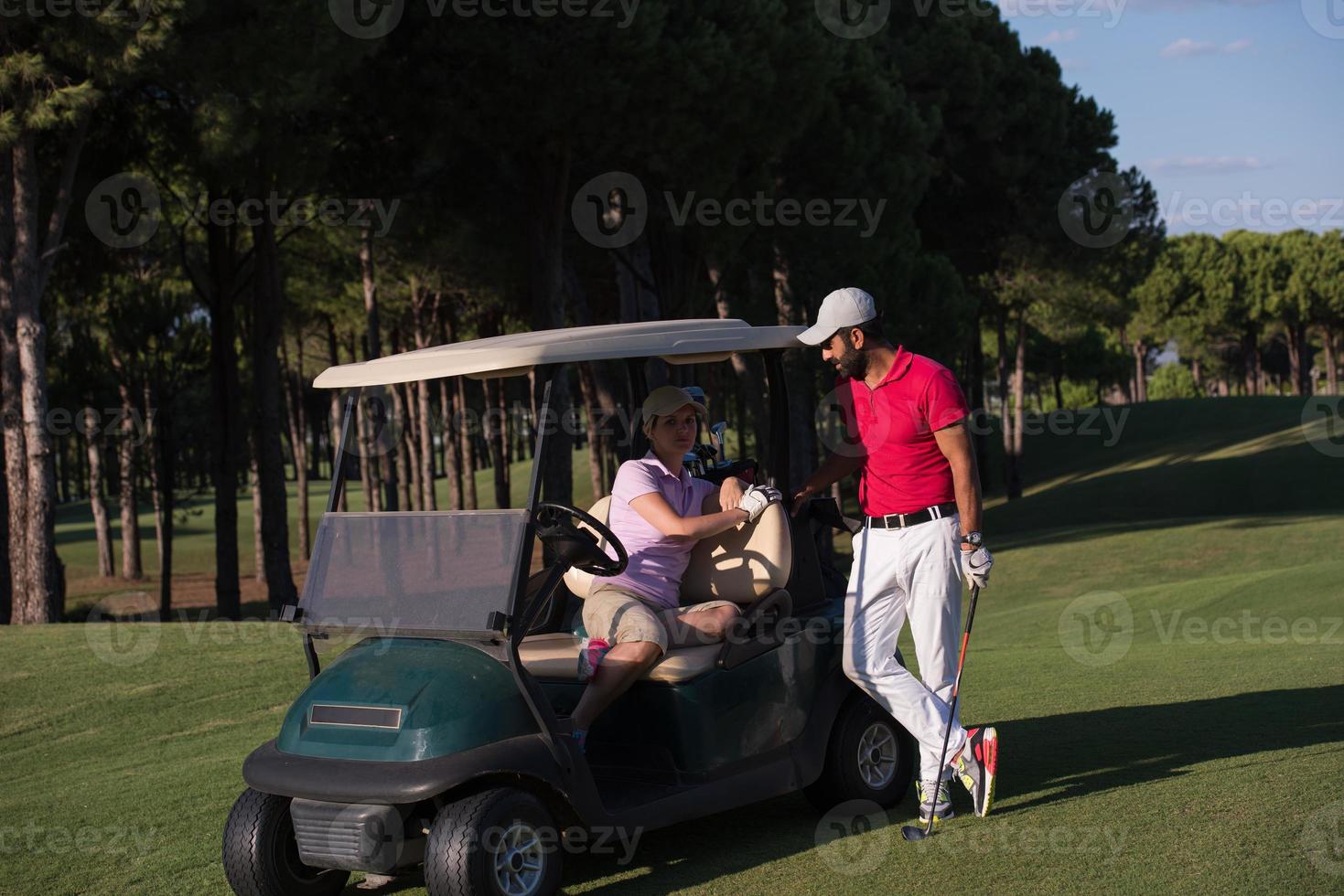 couple in buggy on golf course photo