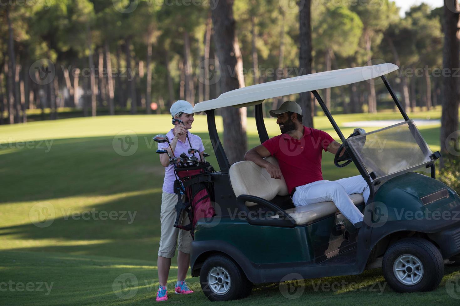 couple in buggy on golf course photo