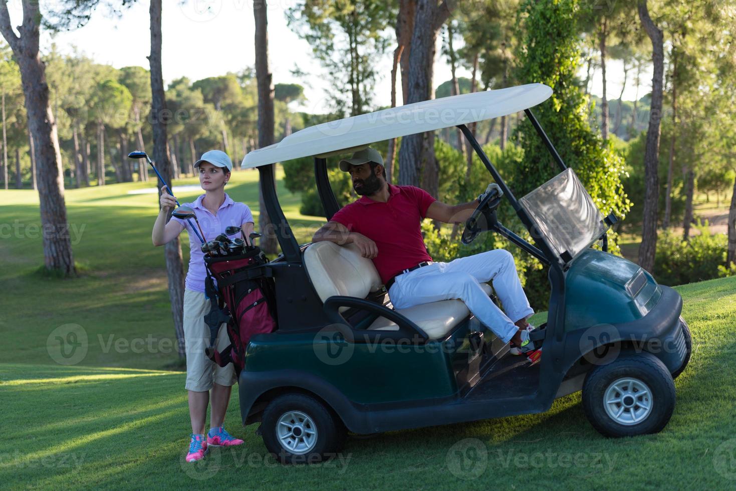 couple in buggy on golf course photo