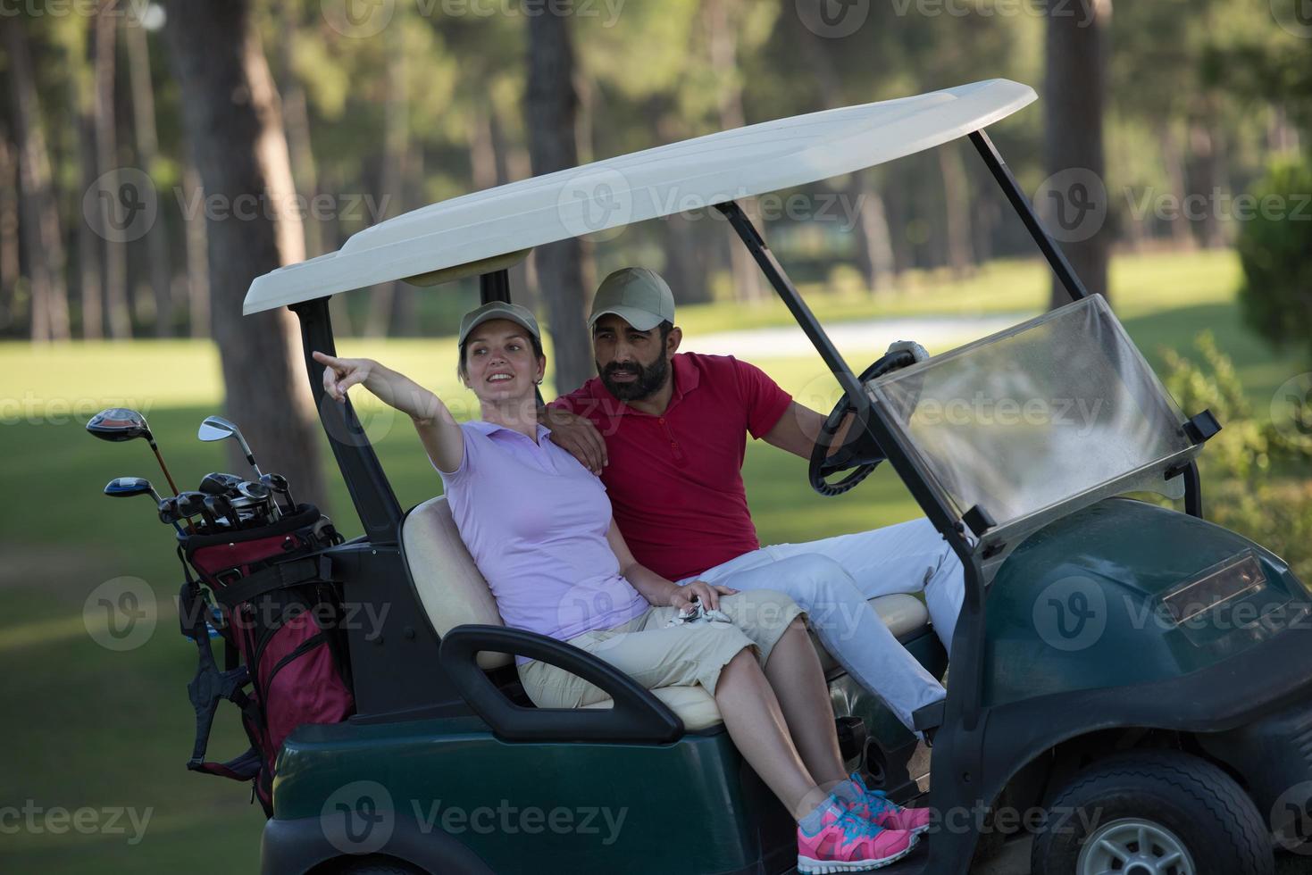 couple in buggy on golf course photo