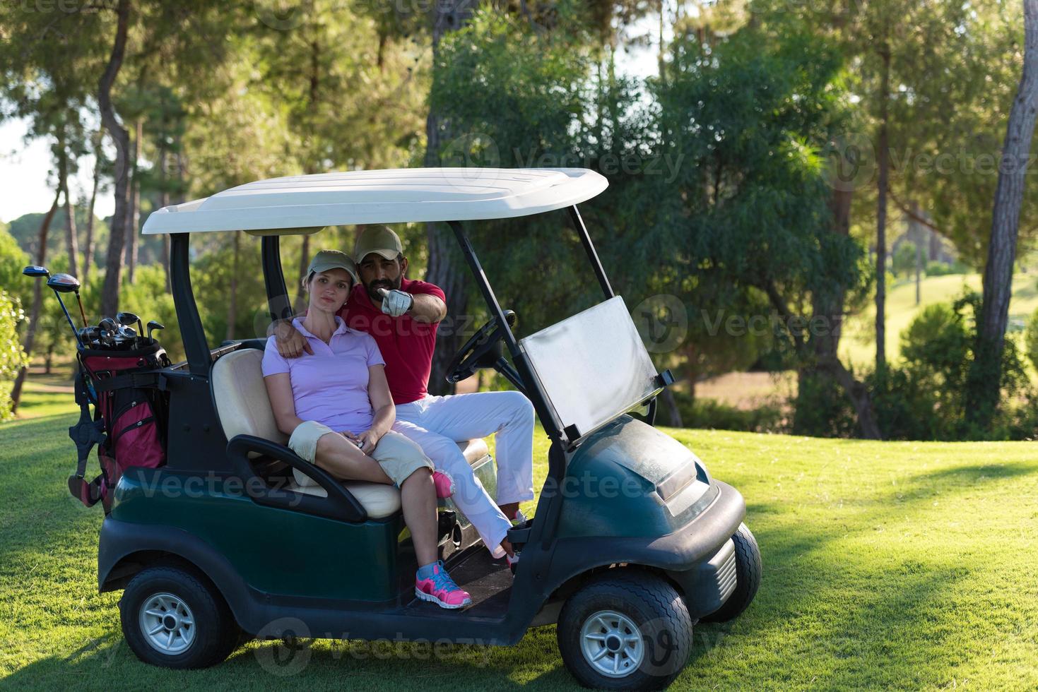 couple in buggy on golf course photo