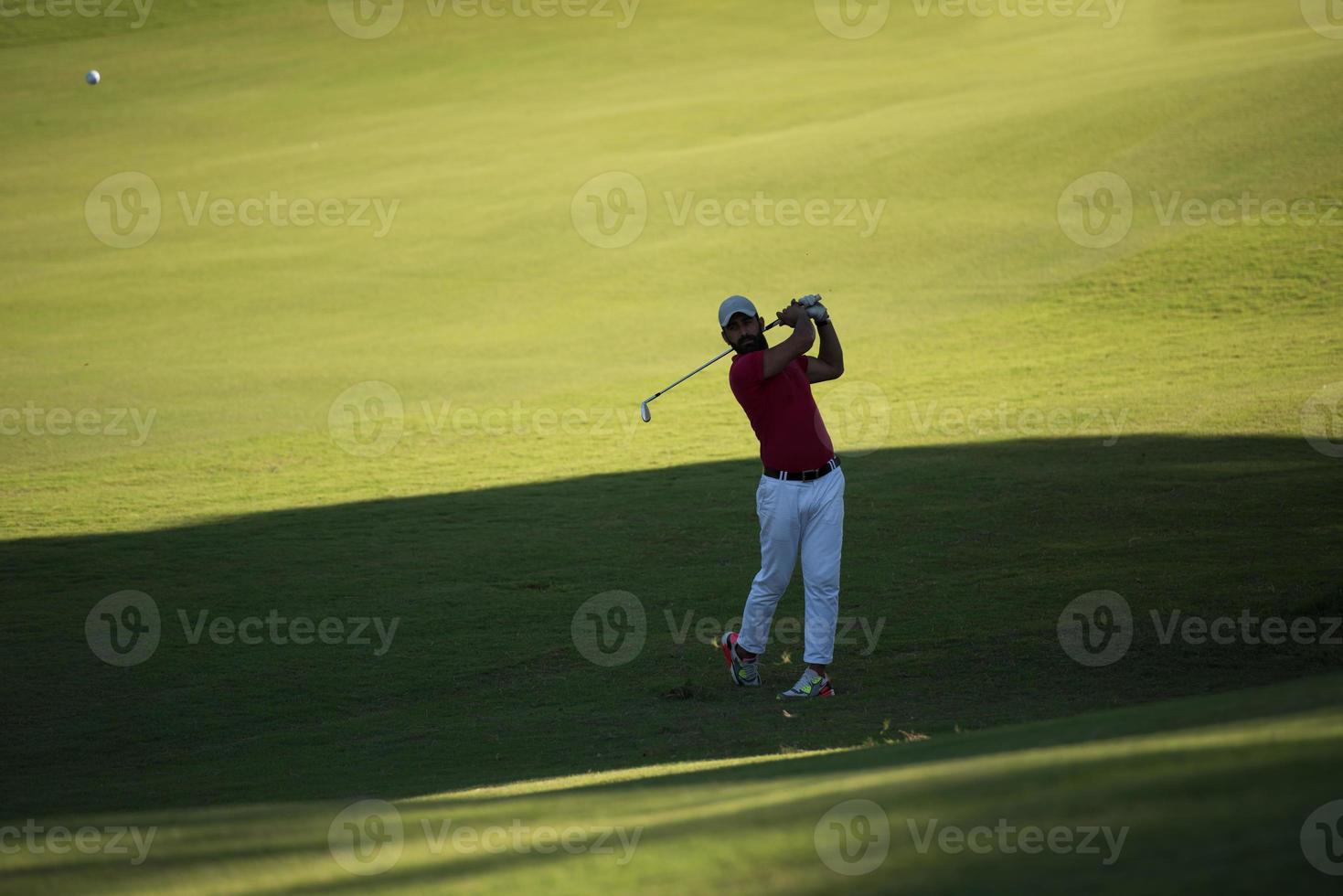 golf player hitting long shot photo