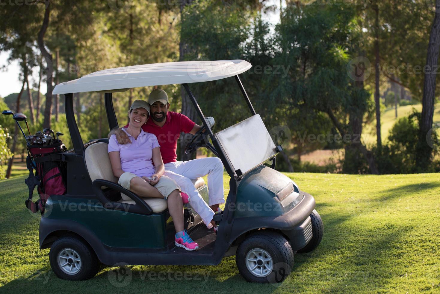 couple in buggy on golf course photo