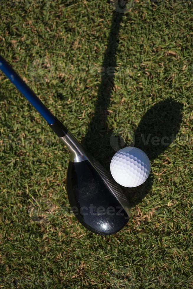 top view of golf club and ball in grass photo