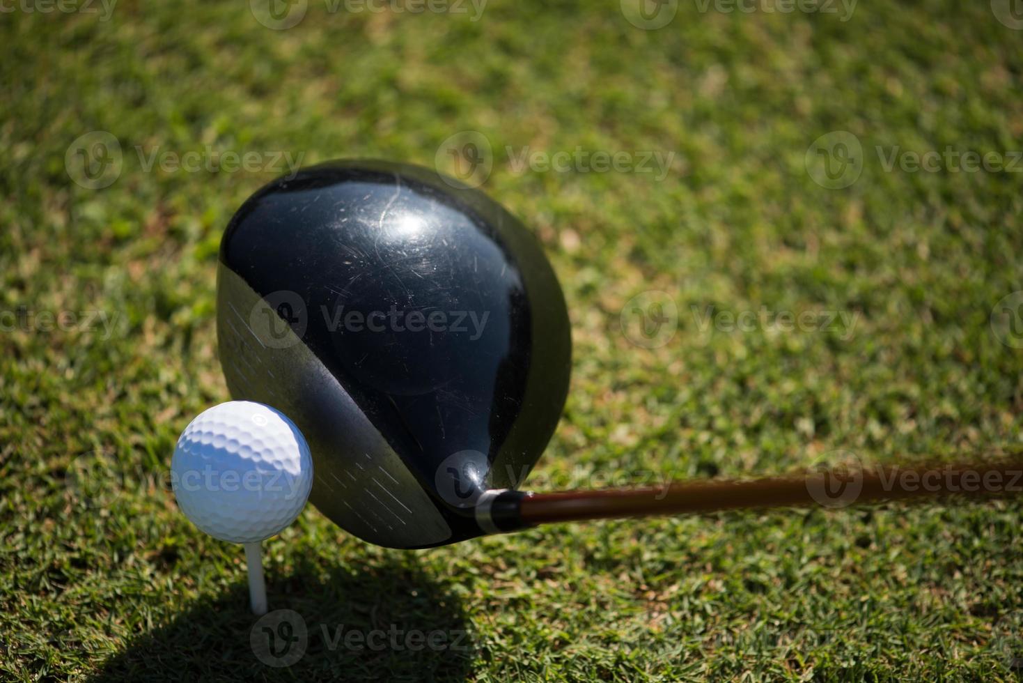 top view of golf club and ball in grass photo