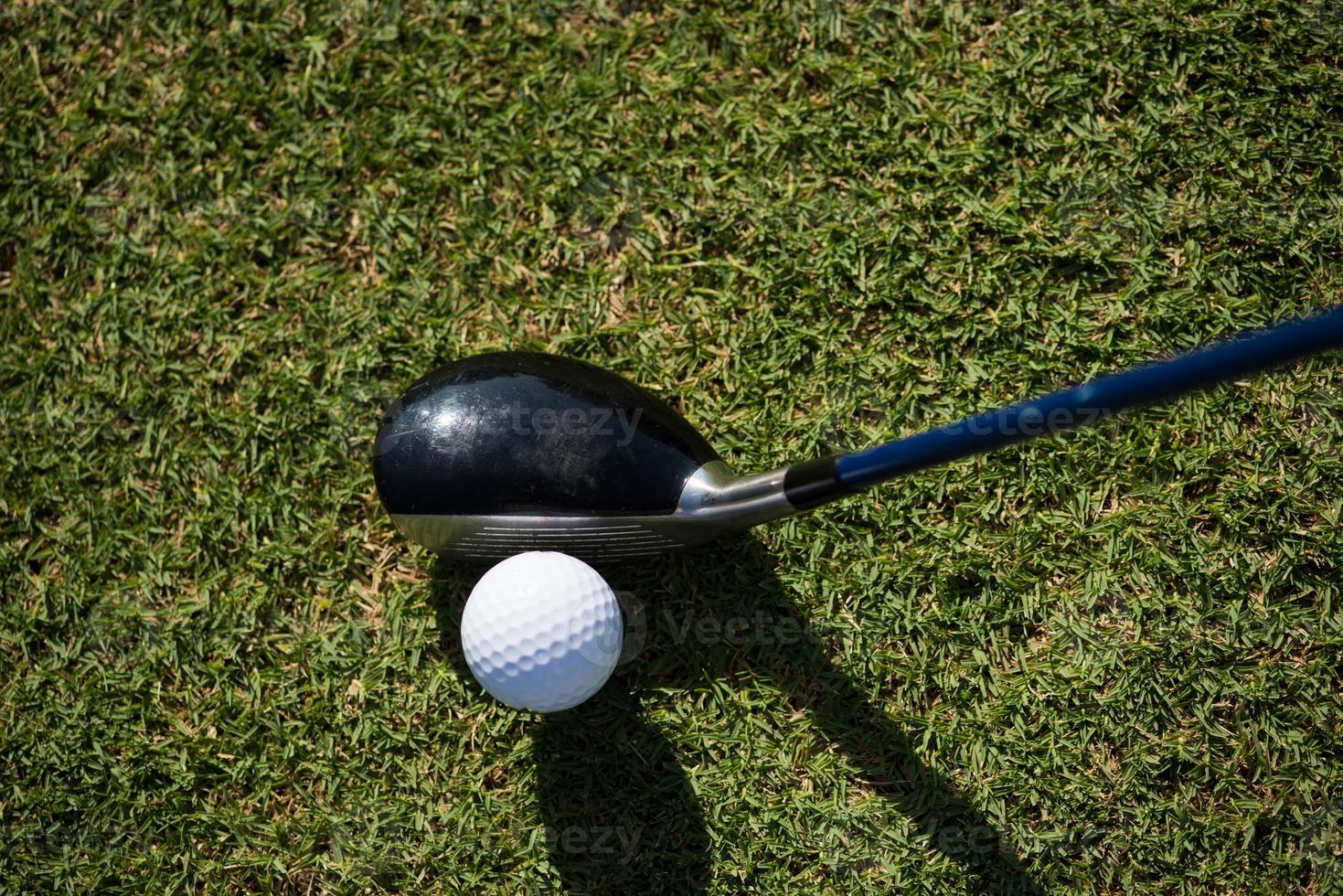 top view of golf club and ball in grass photo