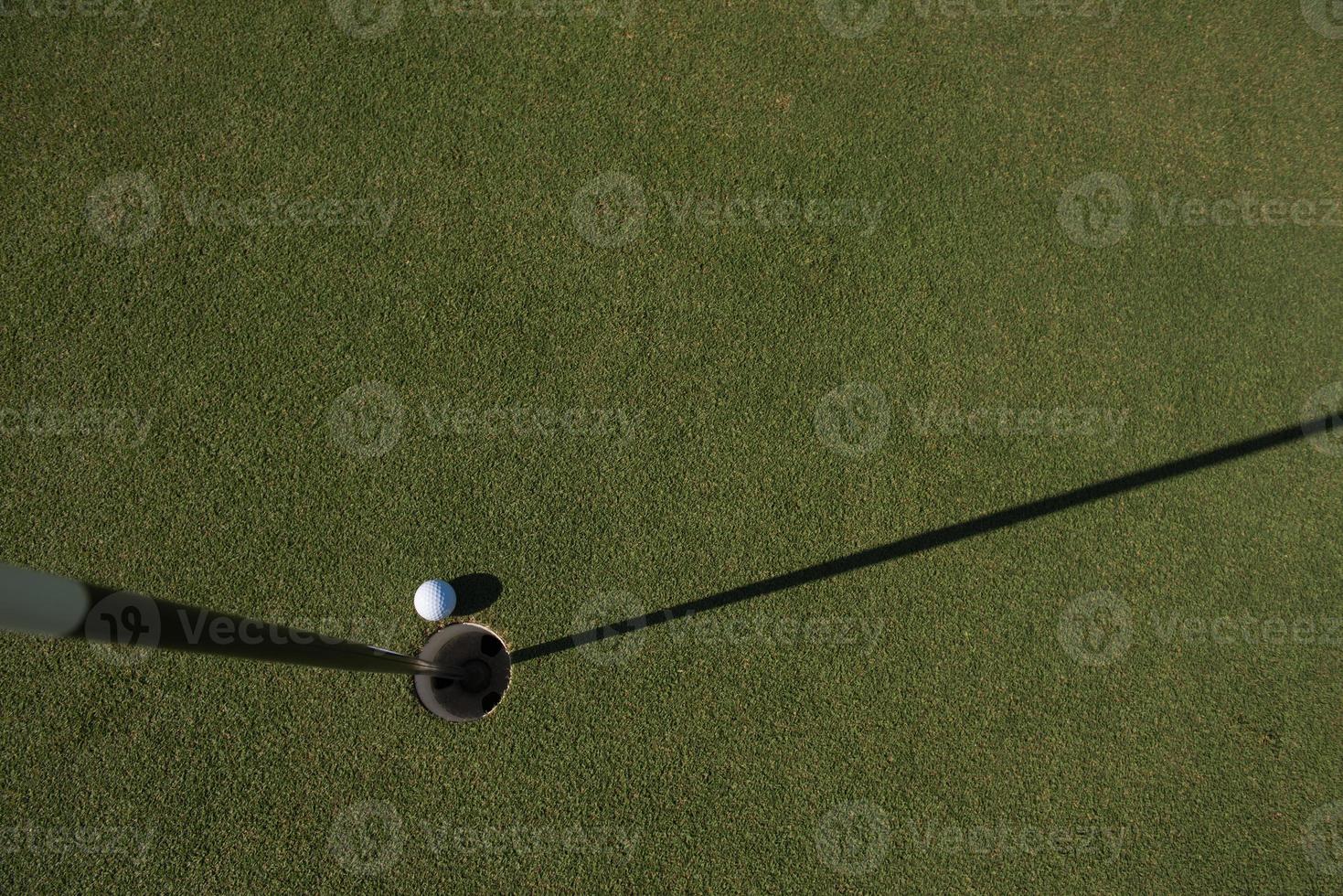 top view of golf ball in the hole photo