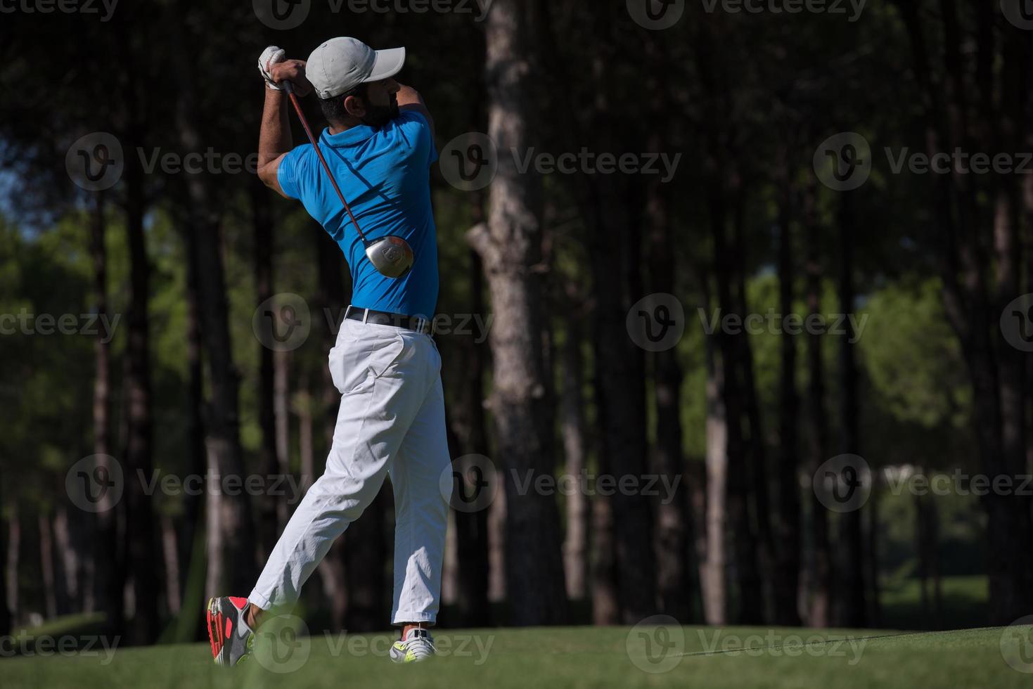 golf player hitting shot photo