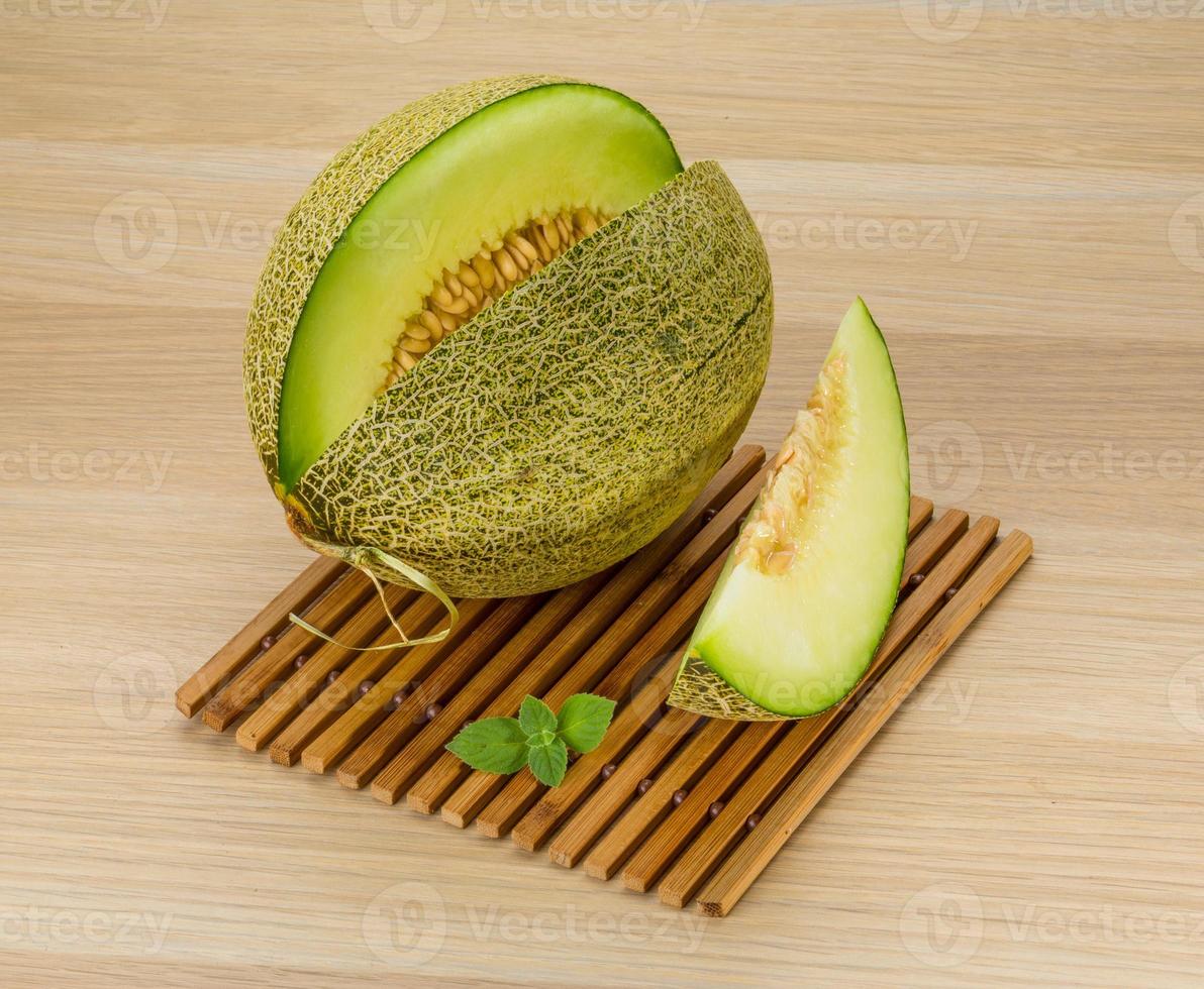 Melon on wooden background photo