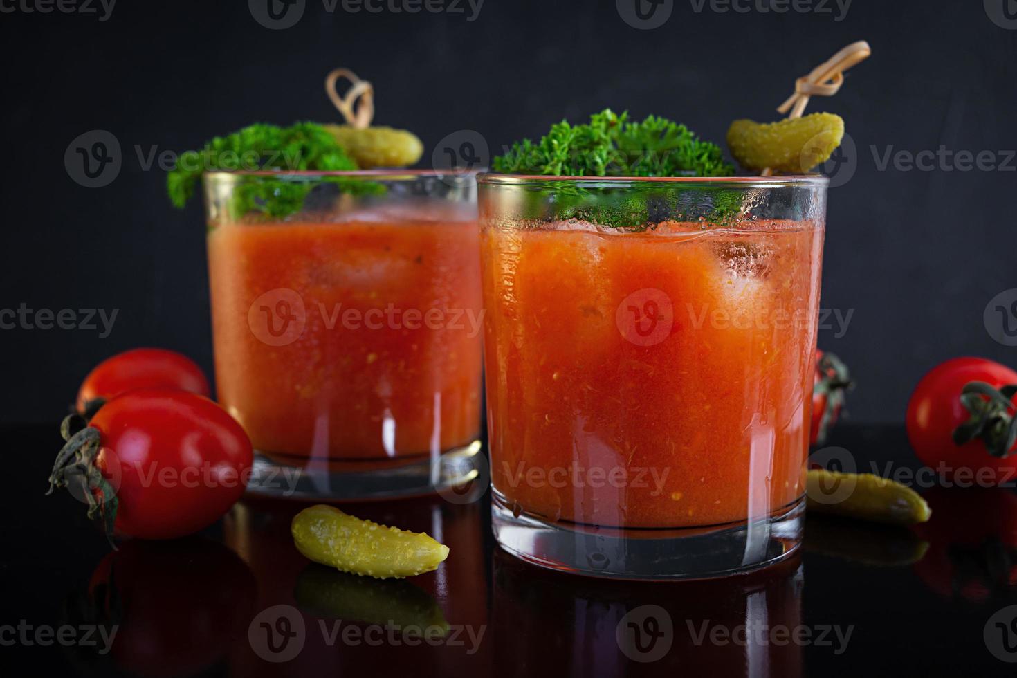 Alcohol cocktail Bloody Mary on dark background. Classic cocktail with tomato juice and vodka photo