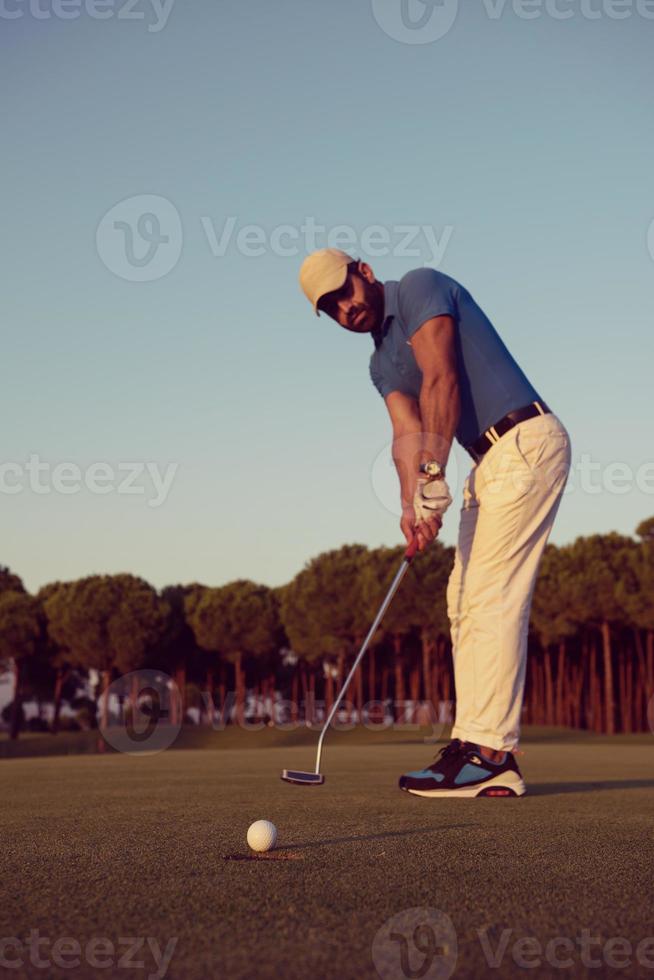 golfer  hitting shot at golf course photo