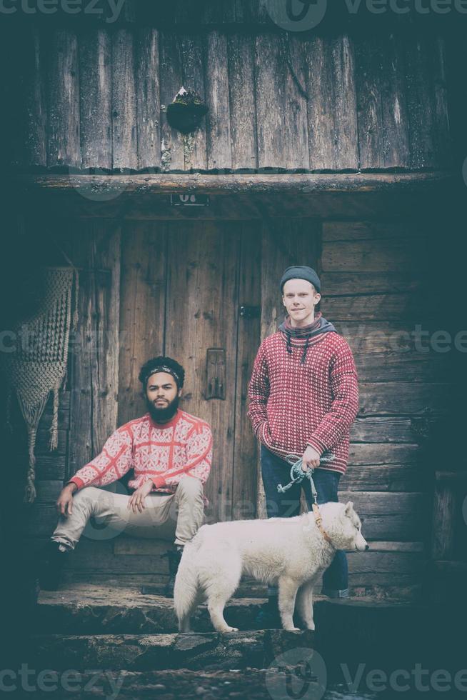 frineds together in front of old wooden house photo