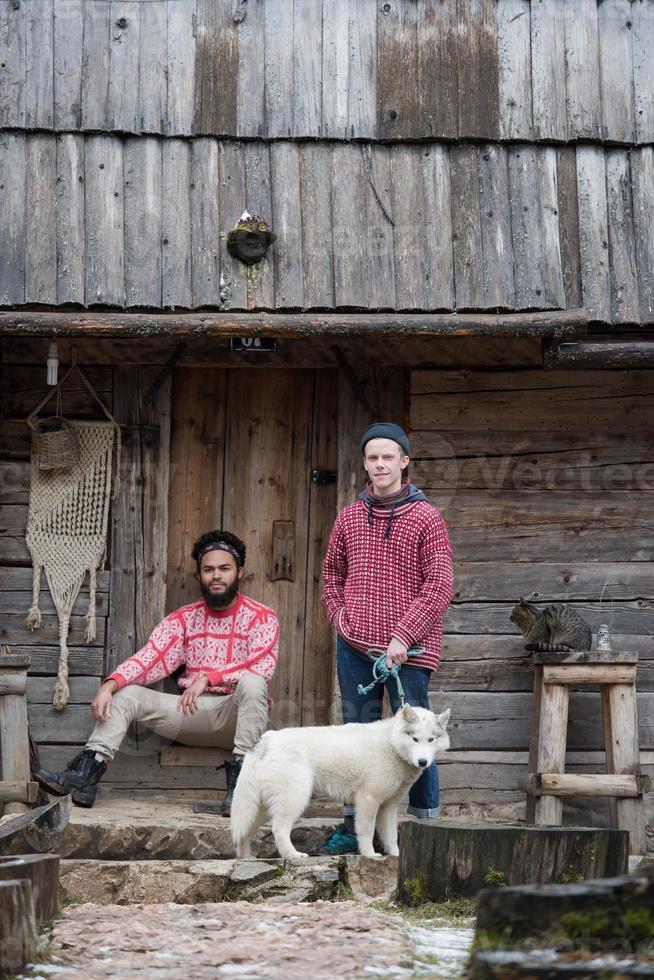 frineds together in front of old wooden house photo