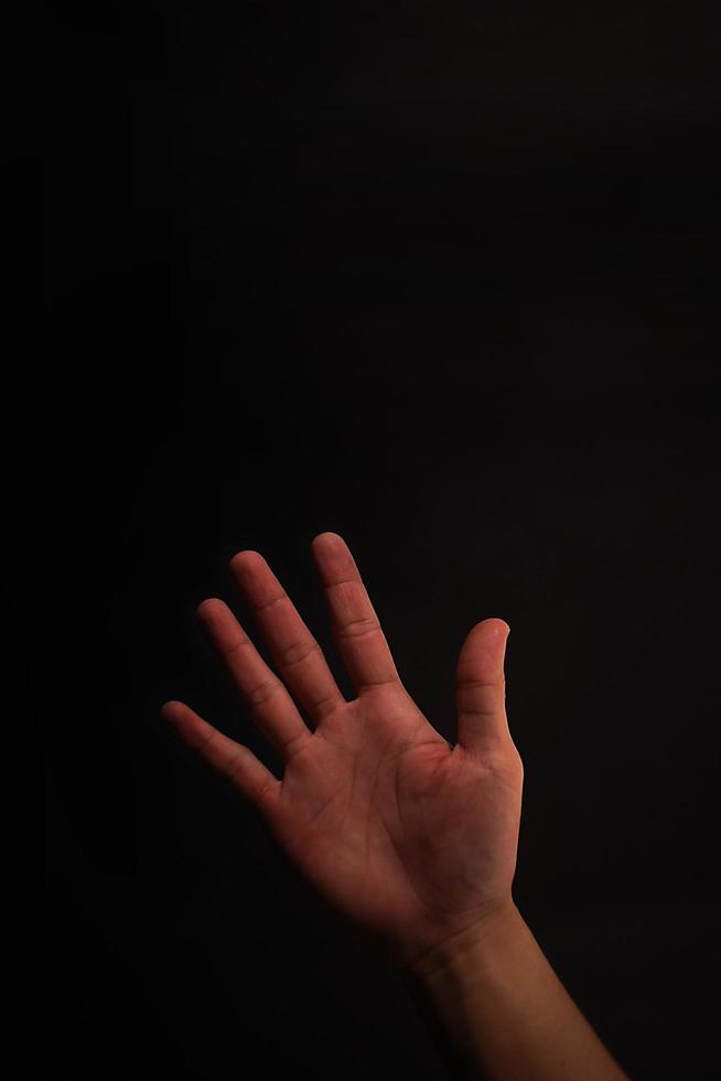 5 finger hand on black background photo