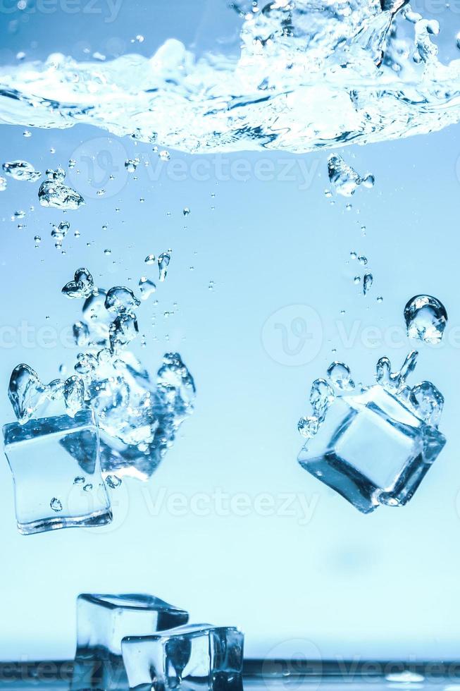 Abstract background image of ice cubes in blue water. photo