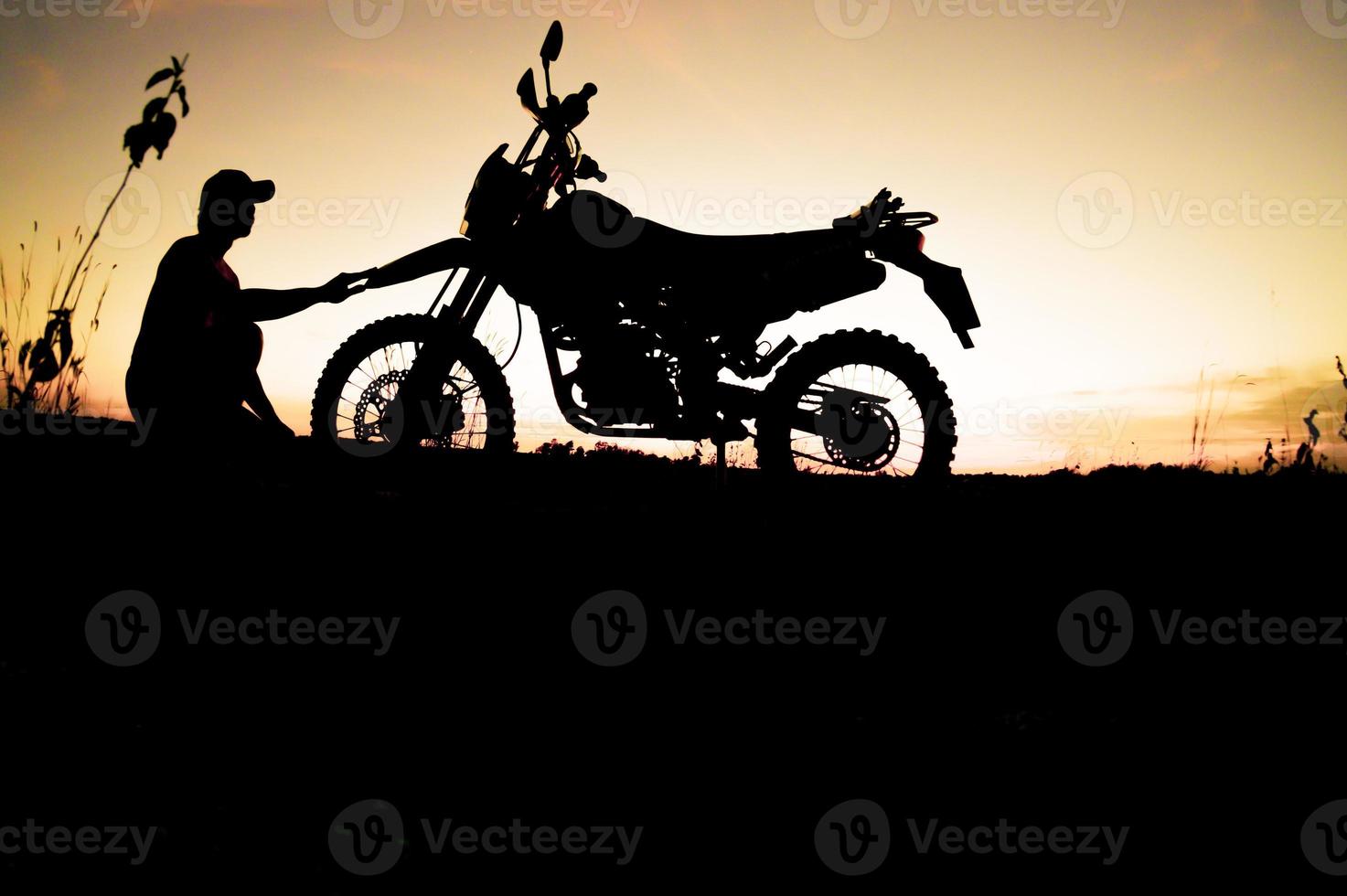 Men's silhouettes and touring motocross bikes. Park to relax in the mountains in the evening. adventure travel and leisure concept photo