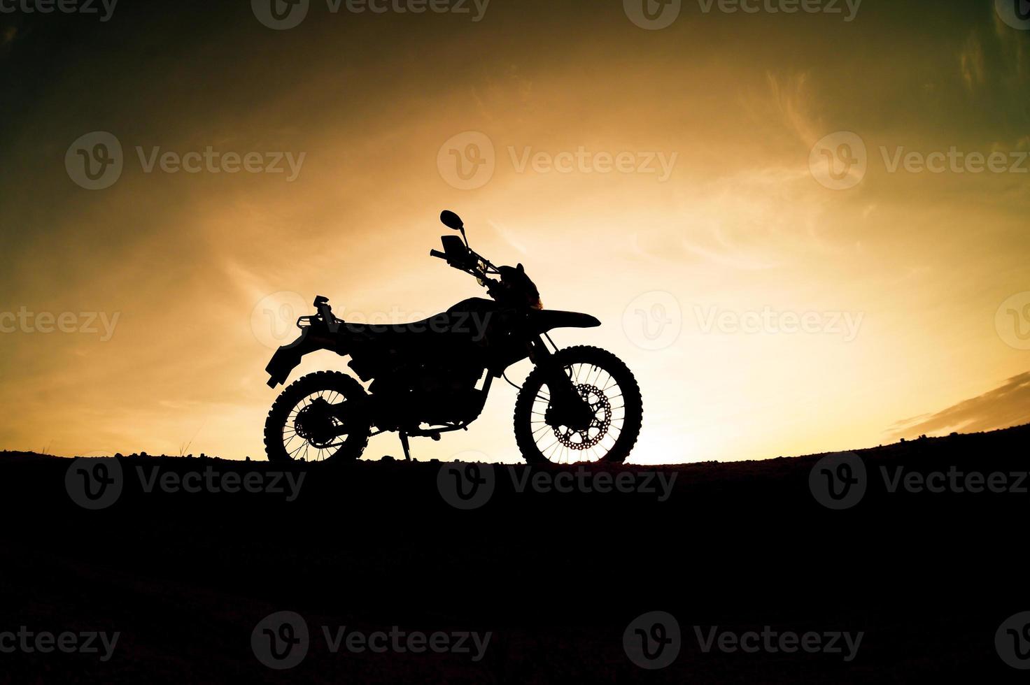 Tourist motorcycle motocross silhouette Park on the mountain in the evening. adventure travel concept photo