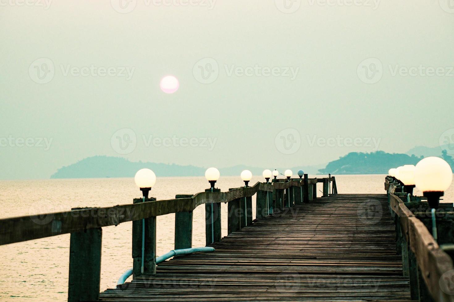 A wooden walkway that stretches into the sea. vacation travel concept photo