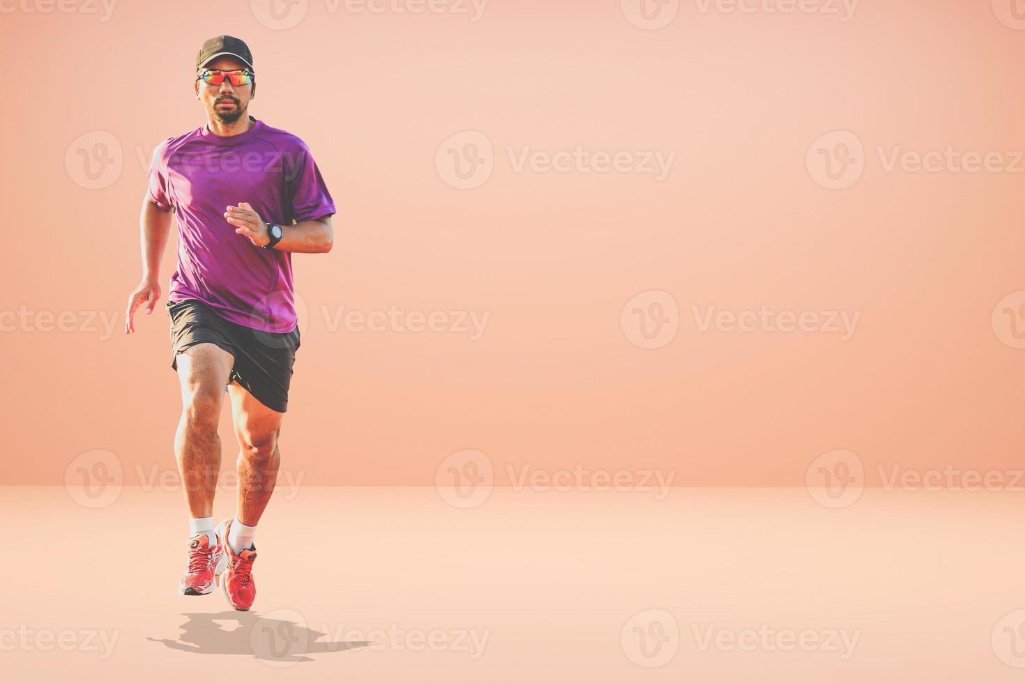 Healthy Asian man running on colored background with copyspace. photo