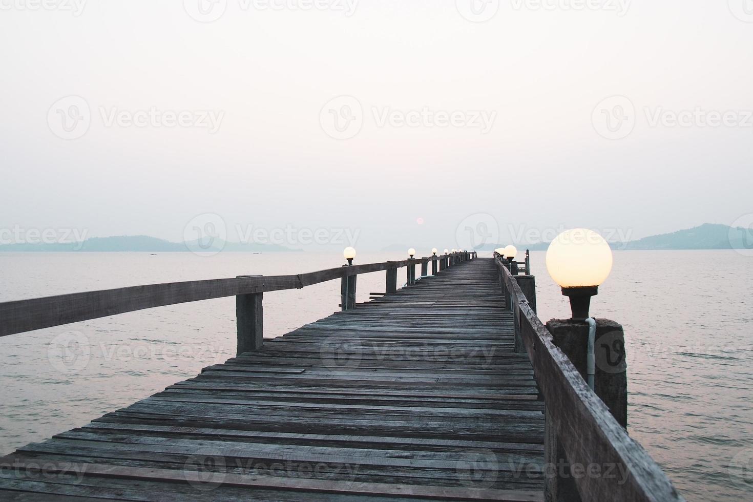 A wooden walkway that stretches into the sea. vacation travel concept photo