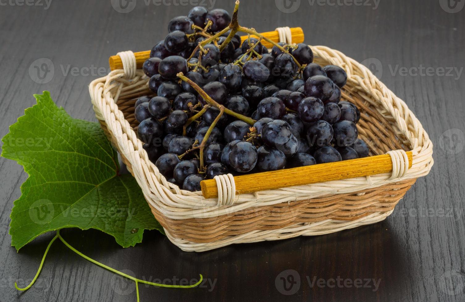 Grape in a basket on wooden background photo