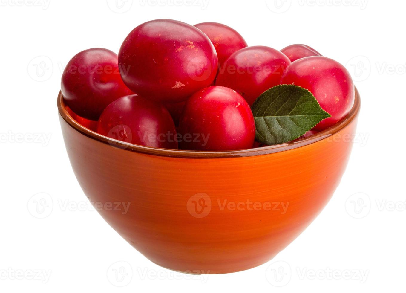 Damson plum in a bowl on white background photo